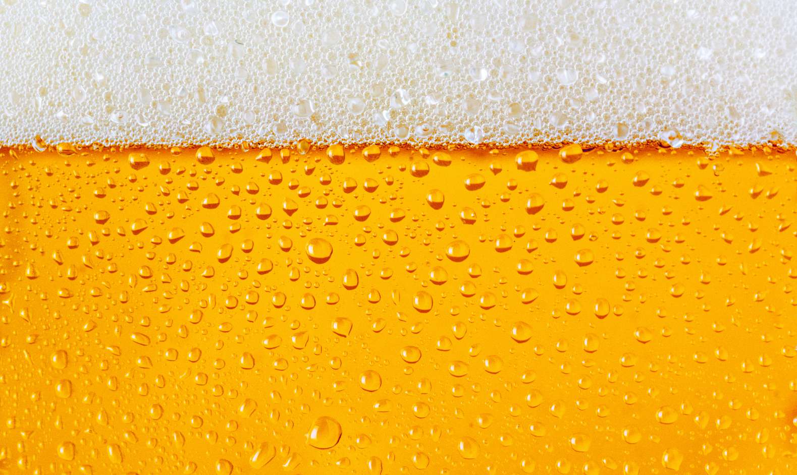 Dewy beer glass texture with froth 